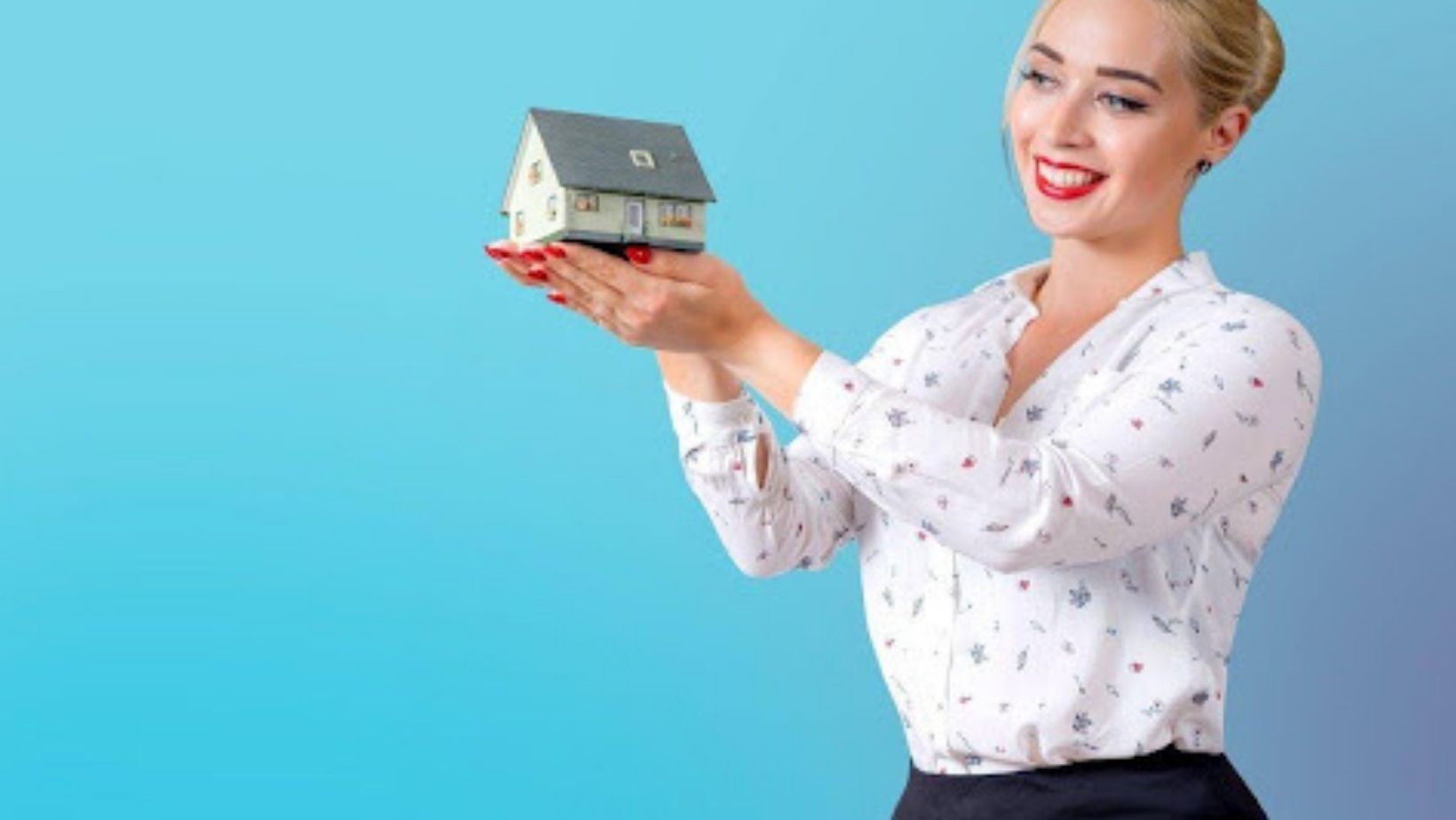 Property Manager Holding a Model House