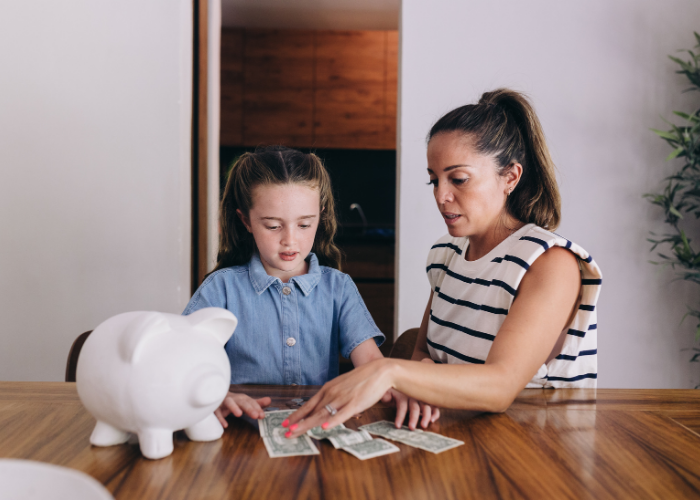 Child Counting Money from Piggy Bank with Mother